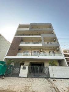 a tall building with a gate in front of it at The Empire Stays , Golf Course Road in Gurgaon