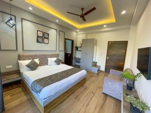a bedroom with a bed and a ceiling fan at The Empire Stays , Golf Course Road in Gurgaon