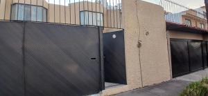 a fence on the side of a building at Residencia El Navegante 1 in Mexico City +4 photos
