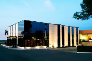 a large glass building with a hotel sign on it at Hotel Juleca in Las Infantas