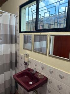 baño con lavabo rojo y ventana en Casa DUNA 2, en La Libertad