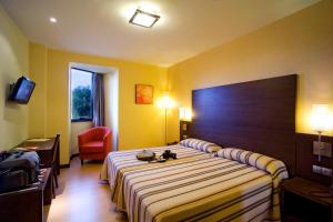 Postel nebo postele na pokoji v ubytování Hotel Juleca