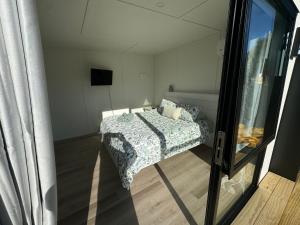a small bedroom with a bed in a room at Abbey Caves Countryscape in Whangarei