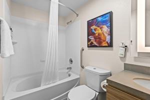a white bathroom with a toilet and a sink at Candlewood Suites Flowood, MS by IHG in Luckney +46 photos