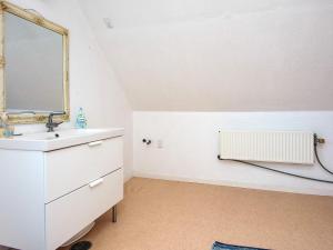 a bathroom with a sink and a mirror at 4 person holiday home in Grenaa in Grenå +44 photos