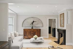 a living room with a couch and a table at Victorian Traditional in Southampton Village in Southampton +26 photos