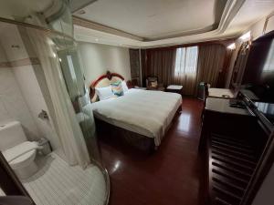a hotel room with a bed and a shower at Happiness Hotel in Taipei