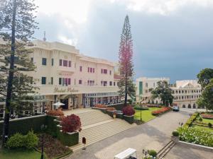 a large white building with a plaza in front of it at Dalat Palace Heritage Hotel in Da Lat
