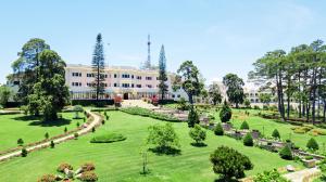 a view of the gardens of a building at Dalat Palace Heritage Hotel in Da Lat