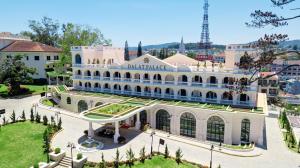 a large white building with a sign on it at Dalat Palace Heritage Hotel in Da Lat