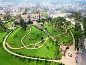 an aerial view of a park in a city at Dalat Palace Heritage Hotel in Da Lat
