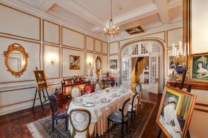 an ornate dining room with a table and chairs at Dalat Palace Heritage Hotel in Da Lat