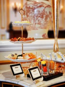 a tray of food on a table with plates of food at Dalat Palace Heritage Hotel in Da Lat