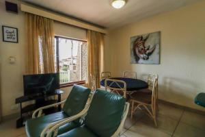 a living room with a table and chairs and a window at Southgate 3 in Margate