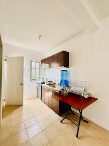 a kitchen with a table with a blue blender on it at Panglao Bohol Transient house in Dauis +4 photos