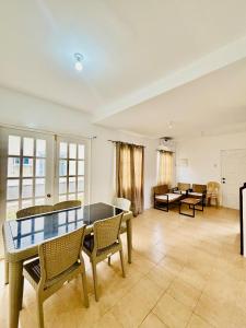 a dining room with a glass table and chairs at Panglao Bohol Transient house in Dauis