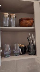 a shelf with glasses and other items on it at La Casa Verde in Seoul
