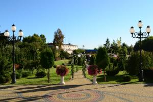 a park with flowers and trees and street lights at Hotel Pałac Akropol in Lublin +10 photos