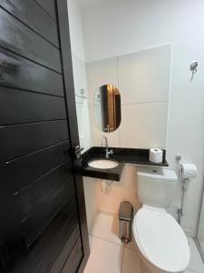 a bathroom with a toilet and a sink at Aloha Noronha Suites in Fernando de Noronha +3 photos