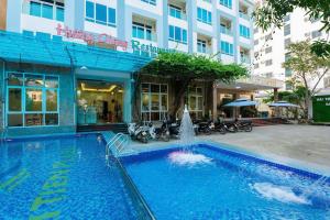 a swimming pool with a fountain in front of a building at Hai Tien Plaza Hotel in Mỹ Ðuc