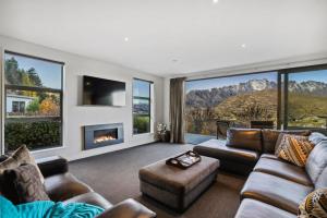 a living room with a couch and a fireplace at Remarkables View Eco House in Queenstown