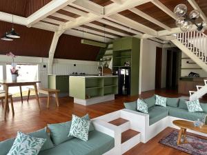 a living room with a couch and a table at DELIMA A Frame House in Singaraja