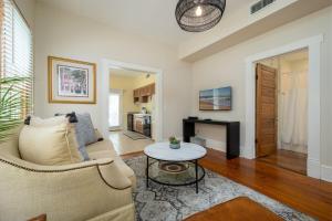a living room with a couch and a table at Be A Nomad - Pool - 1bdr Just 1 Block to the Beach in Jacksonville Beach