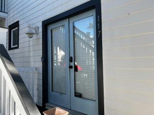 a blue door on the side of a house at Be A Nomad - Pool - 1bdr Just 1 Block to the Beach in Jacksonville Beach