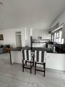 a kitchen with a table and two chairs in it at Three Bedroom House Spacious and Comfortable in Sandton +21 photos