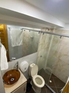 um banheiro com pia, vaso sanitário e chuveiro em Acojedor apto en coveñas em Coveñas mais 12 fotografias