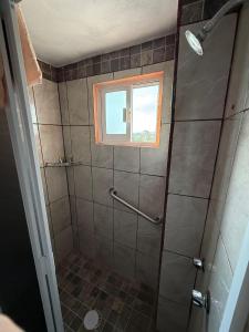 a bathroom with a shower with a window at Hotel La C in San José Iturbide +21 photos