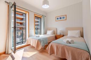 Ένα ή περισσότερα κρεβάτια σε δωμάτιο στο Olhão Beach Apartment +32 φωτογραφίες