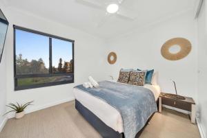 a bedroom with a bed and a large window at Sub-Penthouse with Marina View by Host Solutions in Glenelg +15 photos