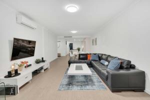 a living room with a couch and a table at Sub-Penthouse with Marina View by Host Solutions in Glenelg