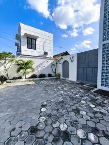 a white house with a stone driveway at Villa Sukun in Yogyakarta +23 photos