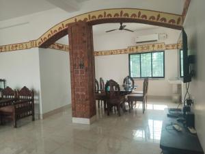 a dining room with a table and chairs at Udita Homestay Prayas in Shānti Niketan