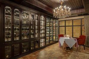a dining room with a table and a chandelier at Anik Palace Hotel in Phnom Penh