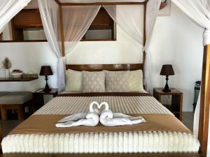 Postel nebo postele na pokoji v ubytování Yapak Beach Villas