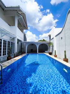 a swimming pool in the backyard of a house at Villa Sukun in Yogyakarta