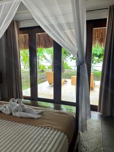 Postel nebo postele na pokoji v ubytování Yapak Beach Villas