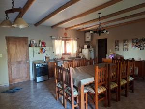 a kitchen with a table and chairs in a room at Cabaña SUSI in General Alvear