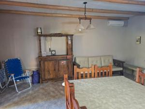 a room with a bed and a table and chairs at Cabaña SUSI in General Alvear