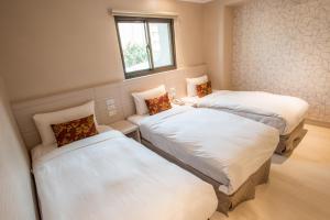 Postel nebo postele na pokoji v ubytování Golden Stone Hotel