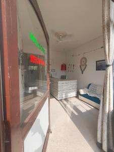a room with a bedroom with a bed and a window at Joystick Guesthouse in Bīr
