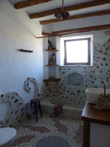 a bathroom with a bath tub and a sink at El molino del abuelo in Montecorto