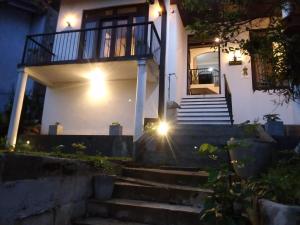 a house with a staircase in front of it at night at Hansa Villa in Galle