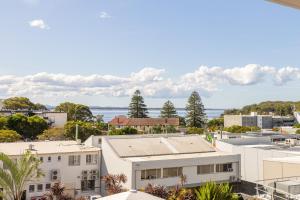 an aerial view of buildings and the ocean at Cote D'Azur 42, 61 Donald St - complex pool, lift, linen, bed making and stunning water views in Nelson Bay