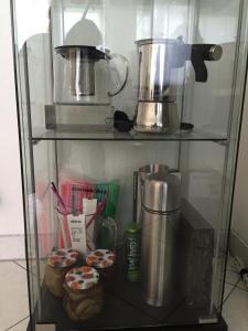 a glass shelf with a blender and some cupcakes at Quiet Oasis Universities/Arts District in Munich