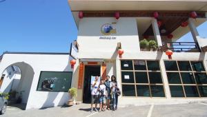 a group of people standing outside of a building at Doichang view in Ban Huai Khai +63 photos