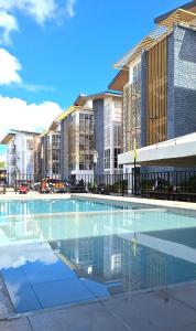an empty swimming pool in front of some buildings at CASA LILIA CEBU near Mactan Airport in Lapu Lapu City